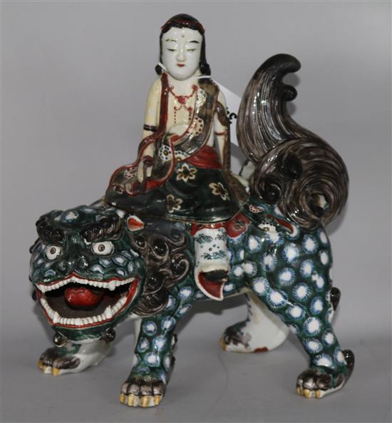 A Chinese ceramic temple dog with figure